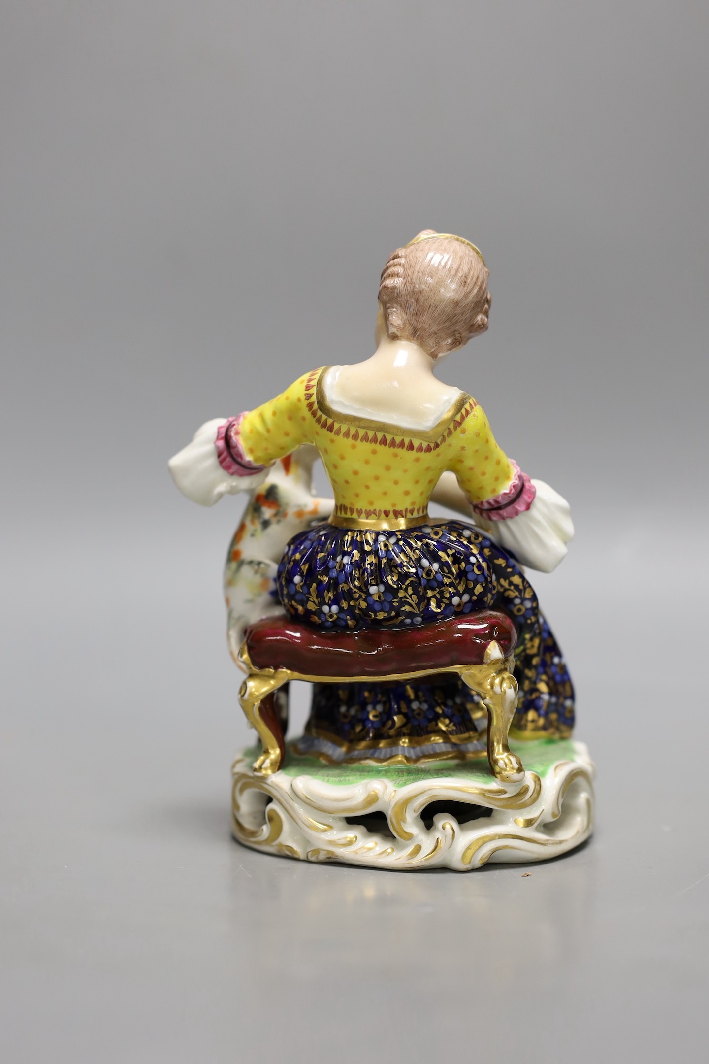 A Bloor Derby porcelain figure of a lady feeding a cat with a spoon, c.1820, No. 362, 15cm tall.